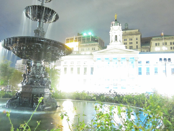 Animation with 8 frames, all of the same fountain with a building in the background. Each photo has a different exposure setting so the first is very bright and the last is rather dark.