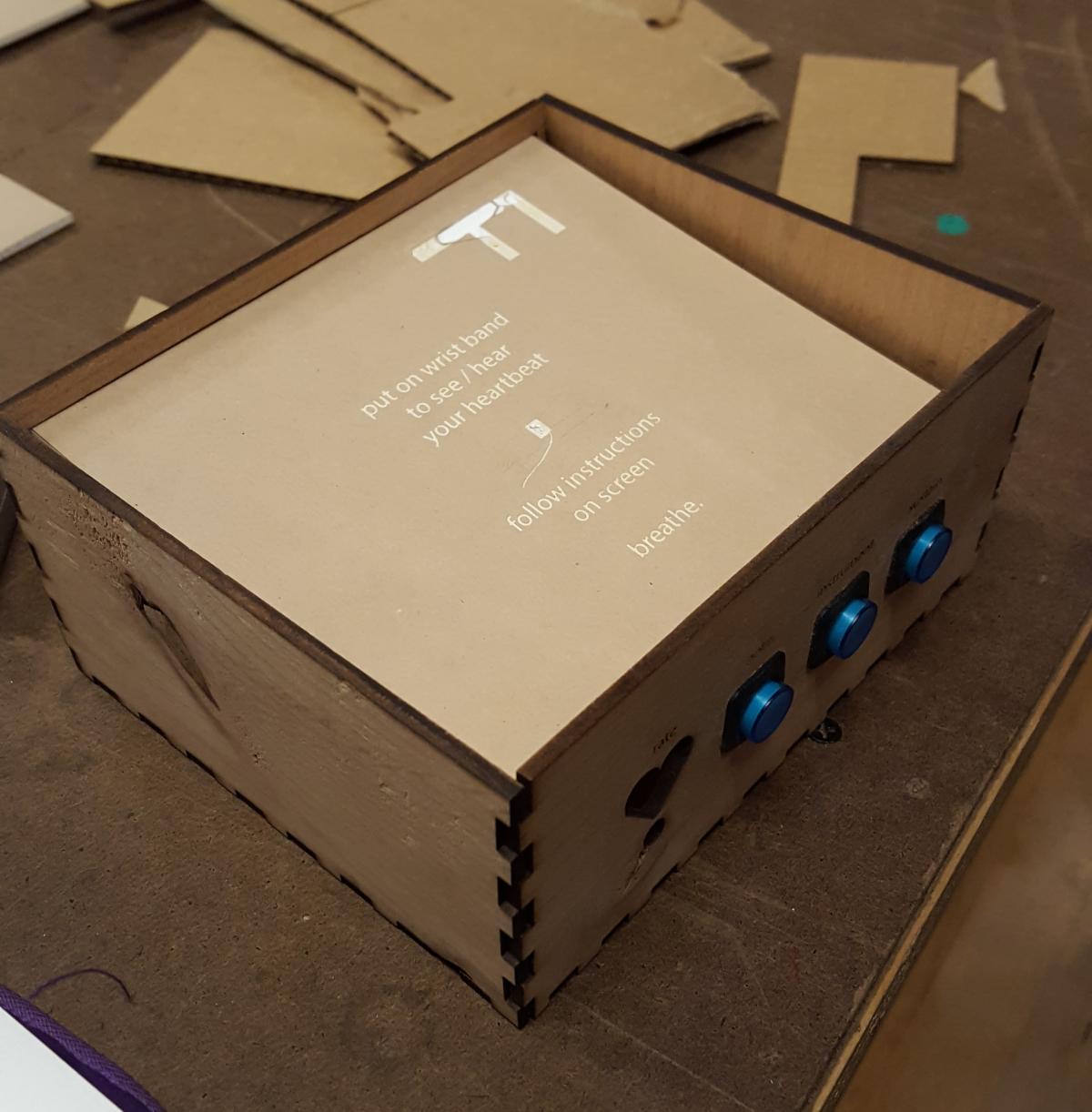 wooden box with acrylic top, instructing the reader to 